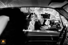 Guests at Villa Bubenzer in Freudenberg, Germany, take photos of the newlyweds next to a vintage Mustang.